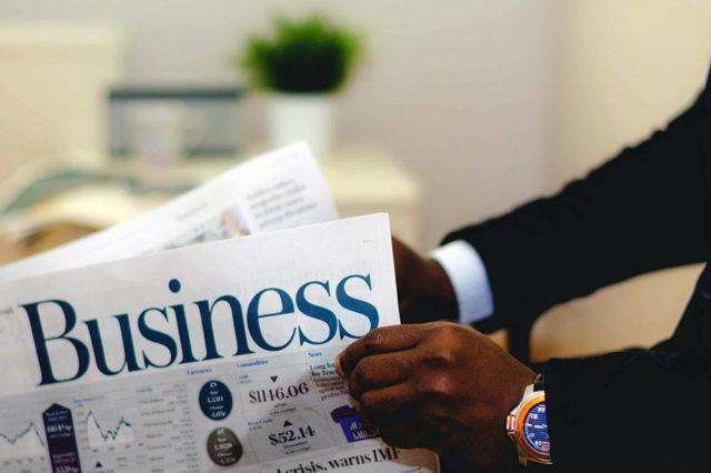 man reading business newspaper